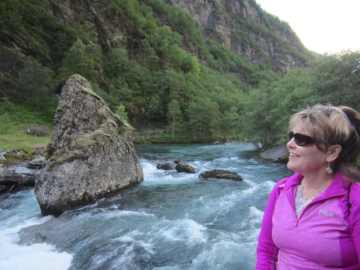 Historic Fretheim Hotel in Flåm overlooking the fjord with mountain backdrop